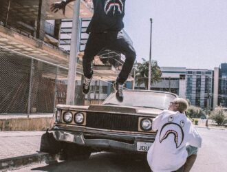 man jumping on front of brown car