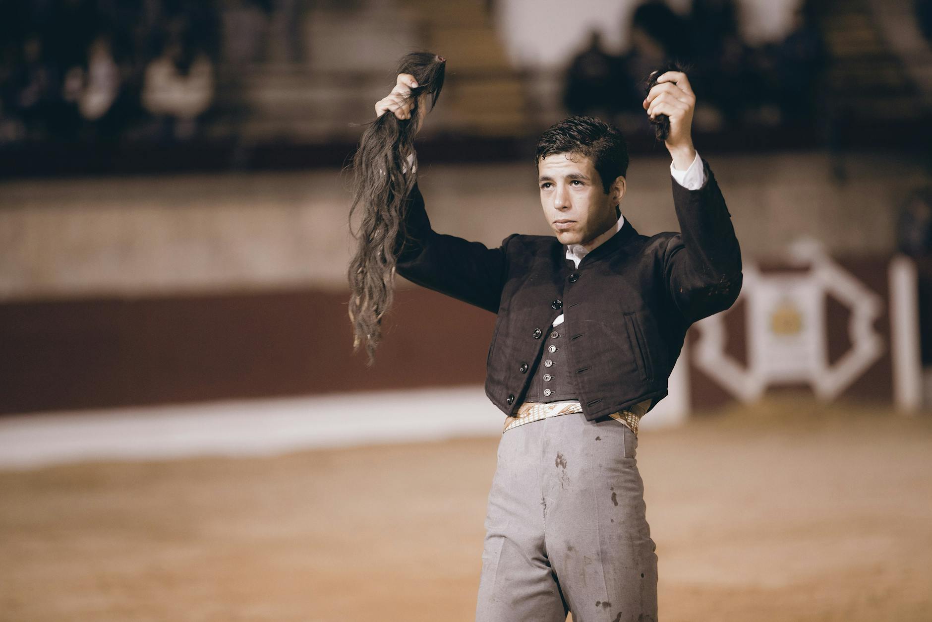 a man holding bull tail